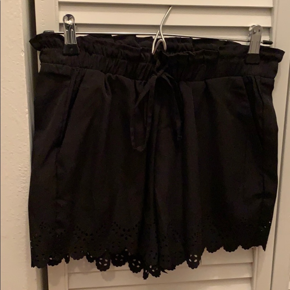 Black paper bag waist shorts with floral cutouts